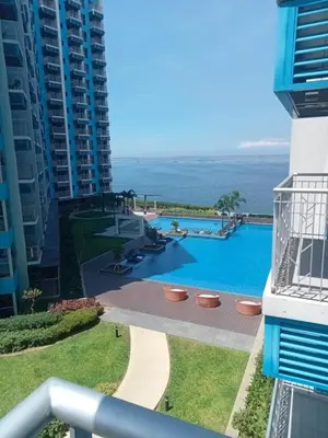 a view of the pool from the balcony of a building at Spacious & Luxury 1BR near Solaire, Okada, Airport in Manila