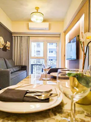 a living room with a table with a plate on it at Spacious 6BR Family Suite near Solaire, Okada in Manila