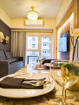 a dining room with a table with a plate on it at Spacious 6BR Family Suite near Solaire, Okada in Manila
