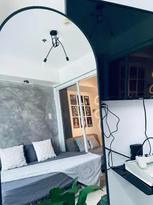 a room with a bed and a mirror at SM Bicutan Staycation Bahamas in Manila