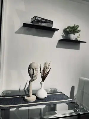 a glass table with a vase and two plants on it at SM Bicutan Staycation Bahamas in Manila