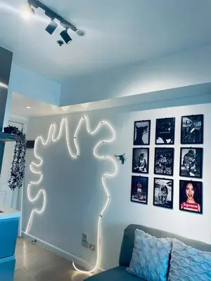a room with a couch and a light on a wall at SM Bicutan Staycation Bahamas in Manila