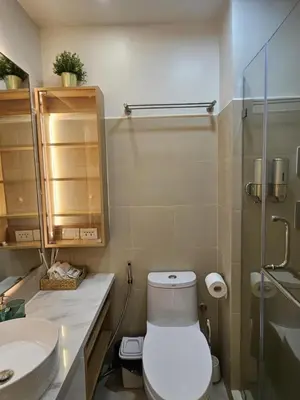 a bathroom with a toilet and a sink at Luxury Condotel Manila by MOA in Manila