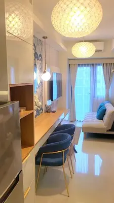 a living room with two chairs and a couch at Luxury Condotel Manila by MOA in Manila