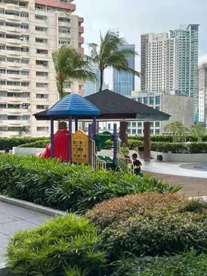 a playground in a park in a city at The Beacon Makati by Christine Suites PH near Greenbelt Mall in Manila