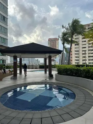 a pavilion with a pool in the middle of a courtyard at The Beacon Makati by Christine Suites PH near Greenbelt Mall in Manila