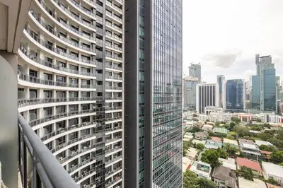 a view from the balcony of a tall building at 1 Bedroom Loft in Gramercy Residences Makati in Manila