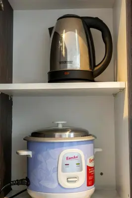 a tea kettle sitting on top of a pot in a refrigerator at 1 Bedroom Loft in Gramercy Residences Makati in Manila