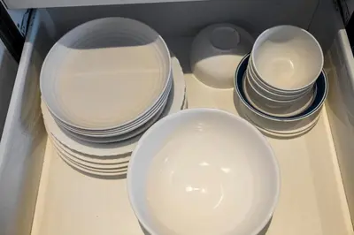 a group of plates and bowls sitting on a table at 1 Bedroom Loft in Gramercy Residences Makati in Manila