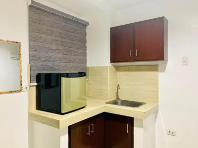 a kitchen with a sink and a microwave at The Seaside Residences in Manila