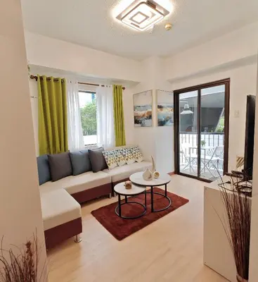 a living room with a couch and a table at Forbes Town in Manila