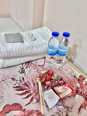 two bottles of water and chopsticks on a table with towels at staycation near manila airport across NAIA terminal 3,13 min drive to terminal 2 and 1, Vexy Condotel located at 101 newport manila in Manila