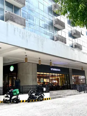 two motorcycles parked in front of a building at staycation near manila airport across NAIA terminal 3,13 min drive to terminal 2 and 1, Vexy Condotel located at 101 newport manila in Manila