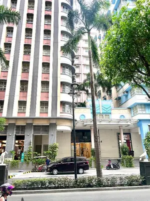 a black car parked in front of a large building at staycation near manila airport across NAIA terminal 3,13 min drive to terminal 2 and 1, Vexy Condotel located at 101 newport manila in Manila