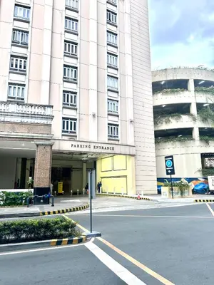an empty street in front of a large building at staycation near manila airport across NAIA terminal 3,13 min drive to terminal 2 and 1, Vexy Condotel located at 101 newport manila in Manila