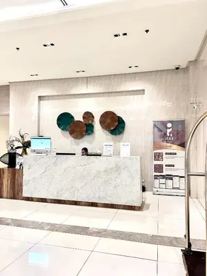 a lobby with a reception desk in a building at staycation near manila airport across NAIA terminal 3,13 min drive to terminal 2 and 1, Vexy Condotel located at 101 newport manila in Manila