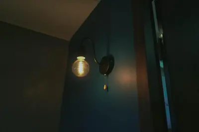 a light on the corner of a room with a door at 1 Bedroom Unit at Venice Luxury Residences in Manila