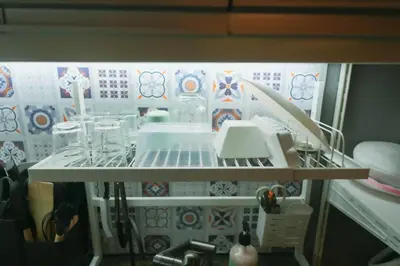 a shelf in a kitchen with dishes and utensils at 1 Bedroom Unit at Venice Luxury Residences in Manila