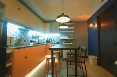 a kitchen with a table and some chairs in it at 1 Bedroom Unit at Venice Luxury Residences in Manila