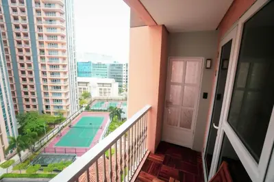 a balcony with a view of a swimming pool at 1 Bedroom Unit at Venice Luxury Residences in Manila