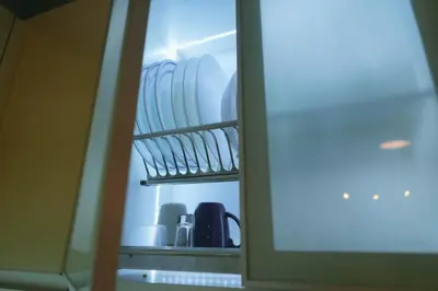 a refrigerator filled with plates and other dishes at 1 Bedroom Unit at Venice Luxury Residences in Manila