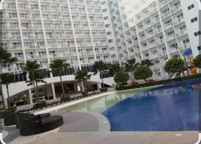 a large apartment building with a large swimming pool at Shore Residences Mall of Asia in Manila