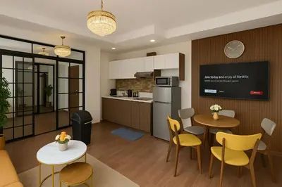 a kitchen and living room with a table and chairs at Skyline escape luxury makati gym swim parking 4649 in Manila