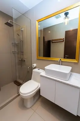 a bathroom with a toilet and a sink and a mirror at Skyline escape luxury makati gym swim parking 4649 in Manila
