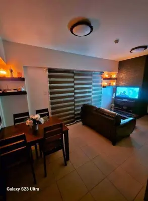 a living room with a couch and a table at 2BR FREE PARKING Calathea Place in Manila