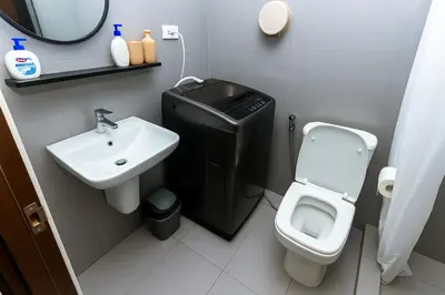 a small bathroom with a toilet and a sink at Royal rise majestic Makati staycation 5338 in Manila