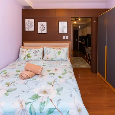 a bedroom with a bed with flowers on it at Royal rise majestic Makati staycation 5338 in Manila