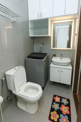 a small bathroom with a toilet and a sink at Metro mood haven Makati relax recharge repeat 1765 in Manila