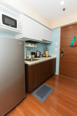 a kitchen with a refrigerator and a sink at Metro mood haven Makati relax recharge repeat 1765 in Manila