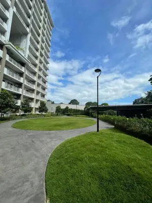 a street light next to a large apartment building at The Atherton by DMCI- 2BR FREE PARKING in Manila