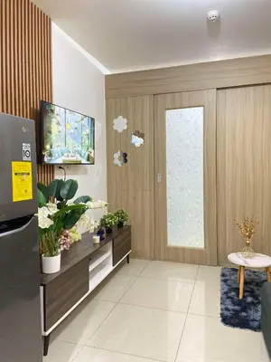 a living room with a tv and a window at Leisure Suite Staycation in Manila