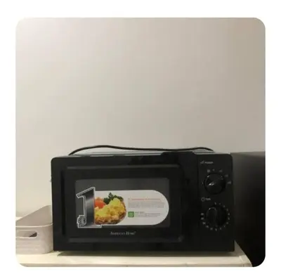 a black toaster oven with a picture of food at Shore 2 Residence Staycation 1 in Manila