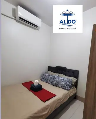 a bedroom with a bed with a black head board at Mall of Asia condotel in Manila