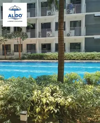 a swimming pool in front of a building at Mall of Asia condotel in Manila