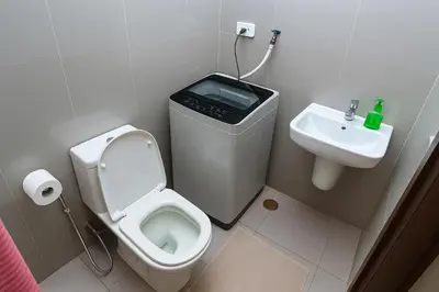 a bathroom with a toilet and a sink at SkyVista Luxe Makati Staycation Pool Gym Netflix 5637 in Manila