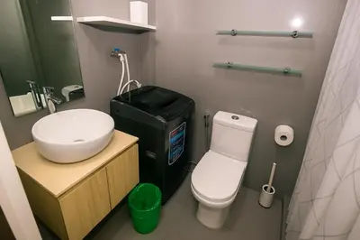 a small bathroom with a sink and a toilet at The Comfy Cove Swim Stream in Central Makati 2272 in Manila