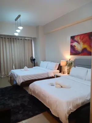 a hotel room with two beds in a room at M&N Condotel in Manila