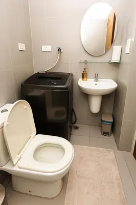 a bathroom with a toilet and a sink at Sunlit Makati Haven Cozy 1BR Gym Pool 1703 in Manila