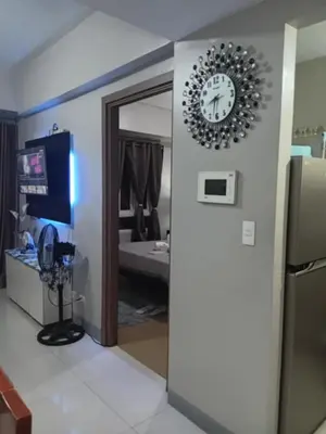 a clock hanging on a wall in a room at M&N Condotel in Manila