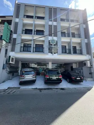 two cars parked in front of a hotel at Gimaca Boutique Hotel in Manila