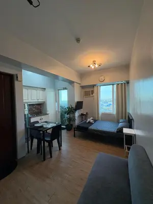 a living room with a couch and a table at Peaceful Getaway in Manila