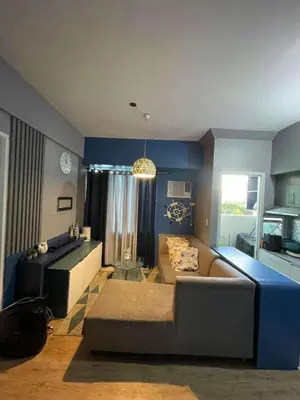 a living room with a couch and a table at Peaceful Getaway in Manila