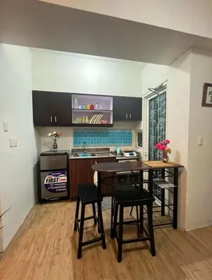 a kitchen with a table and chairs in a room at Peaceful Getaway in Manila