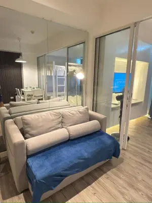 a living room with a couch and a table at Azure Residences Getaway in Manila