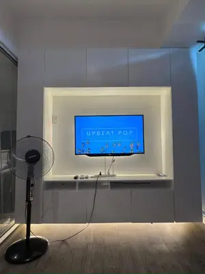 a flat screen tv on a wall in a room at Azure Residences Getaway in Manila
