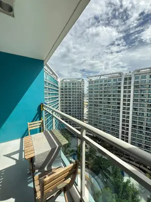 a balcony with a bench and some tall buildings at Azure Residences Getaway in Manila